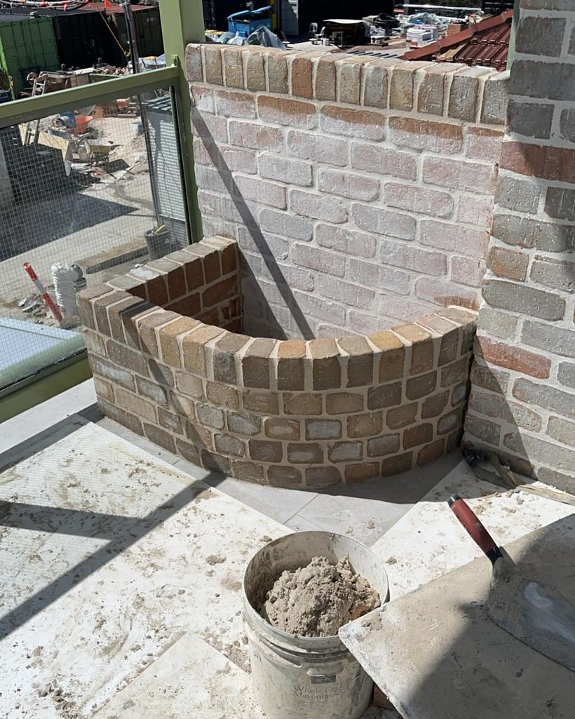 Small curved brick planter box wall