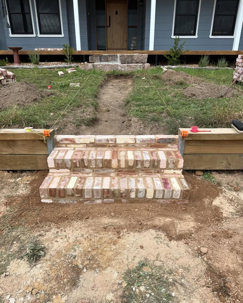 First brick treads laid for new front steps