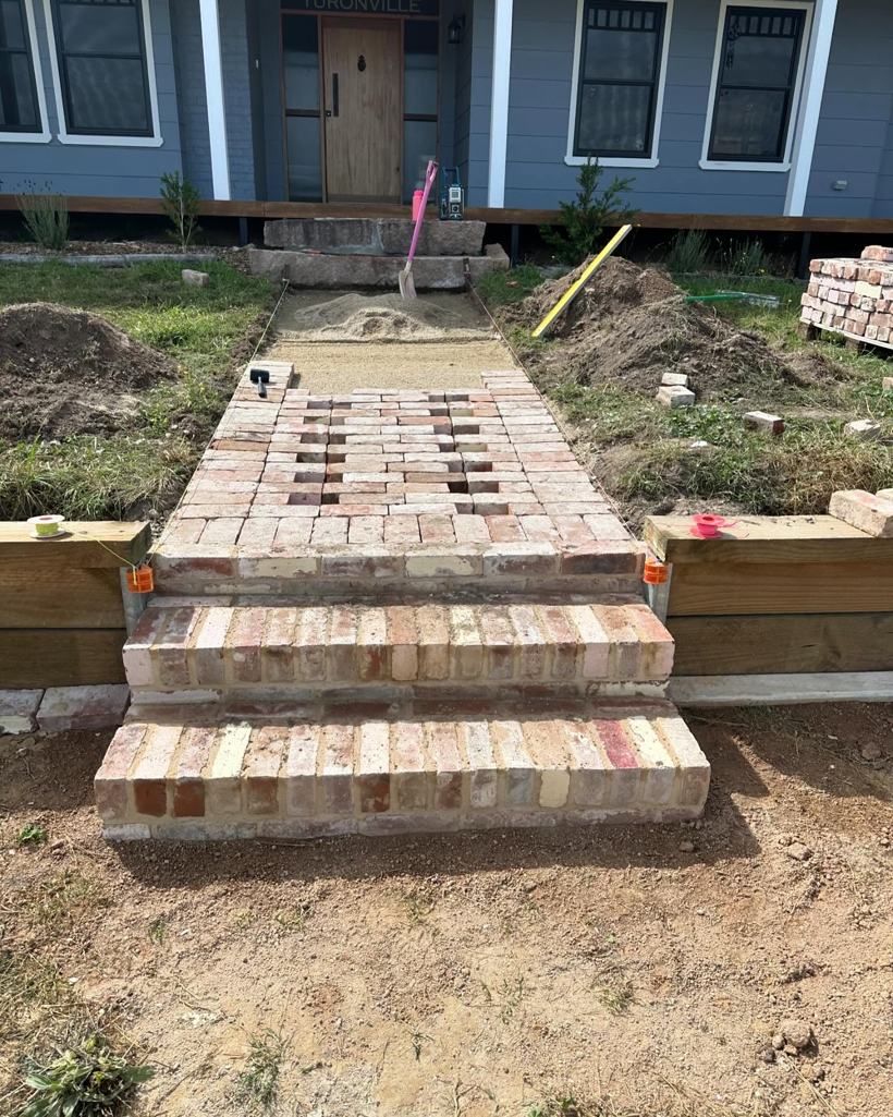 Brick steps and path being laid to a front verandah